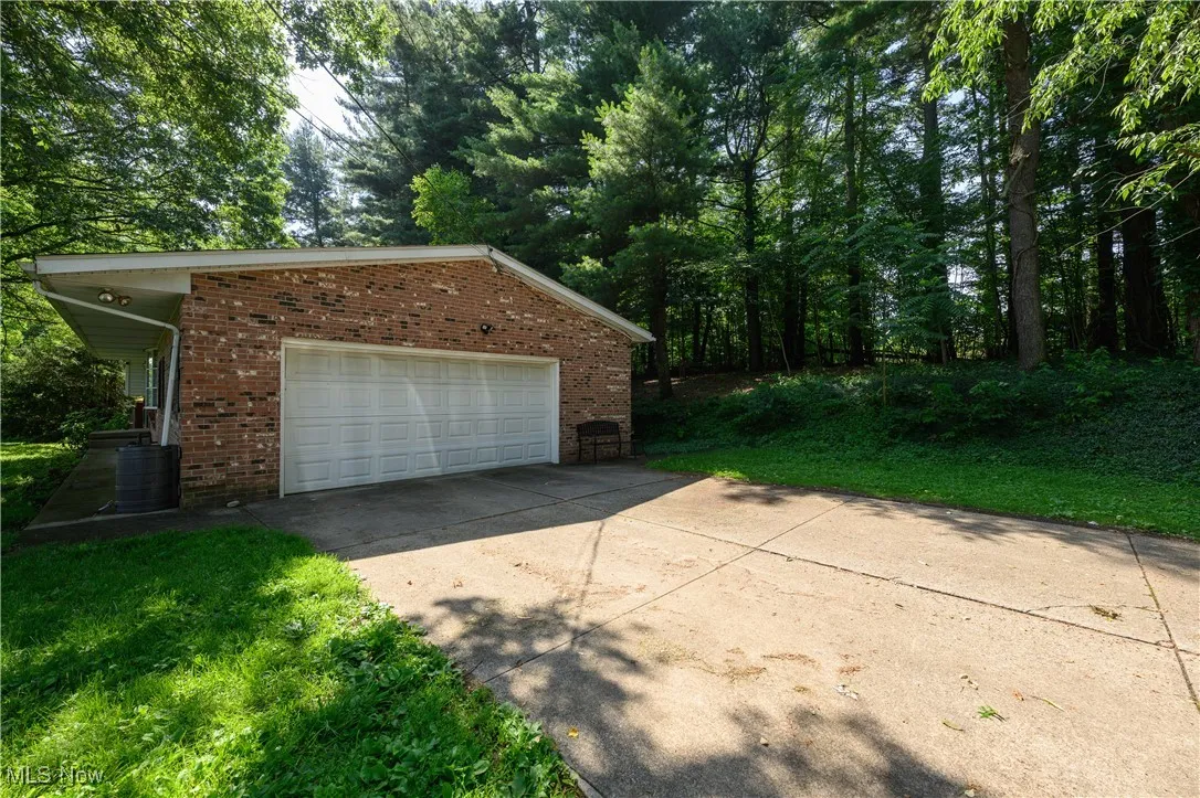 Garage featuring concrete driveway