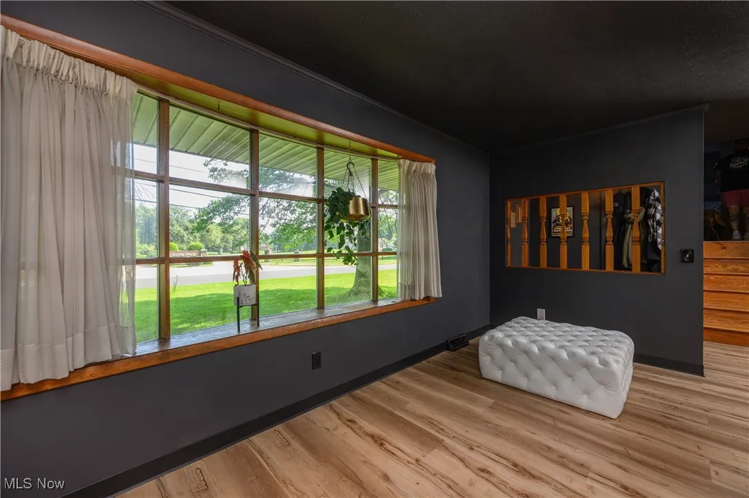 Sitting room with healthy amount of natural light and wood finished floors