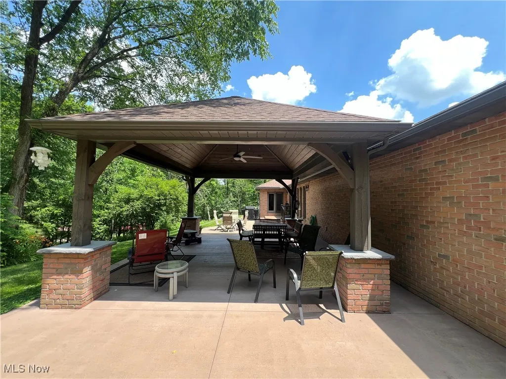 View of patio / terrace with a gazebo, outdoor dining space, and ceiling fan