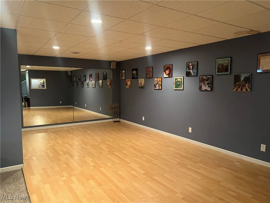 Dance floor/workout area featuring wood finished floors, a paneled ceiling, and recessed lighting
