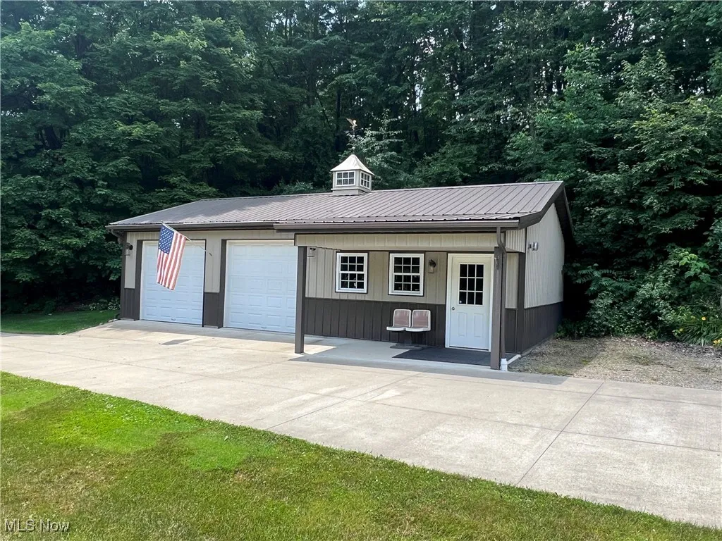 Detached garage with a view of trees