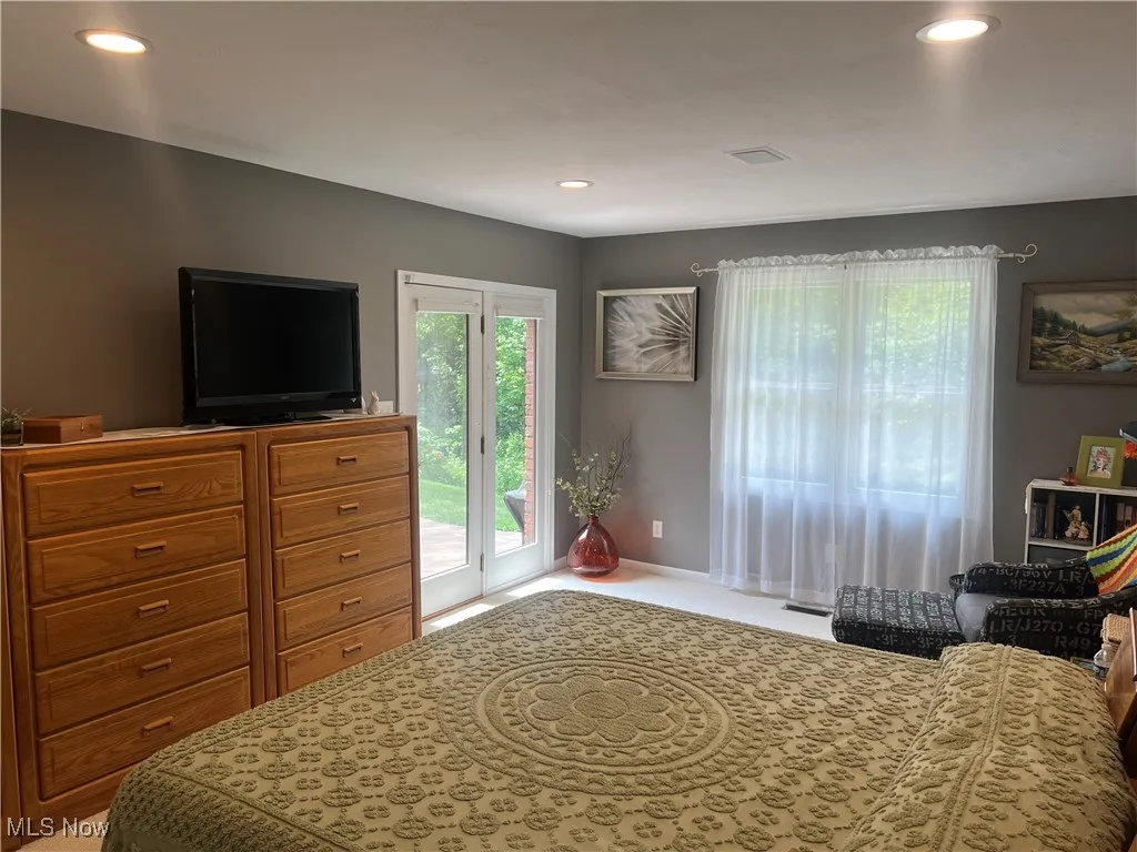 Bedroom with access to exterior and recessed lighting