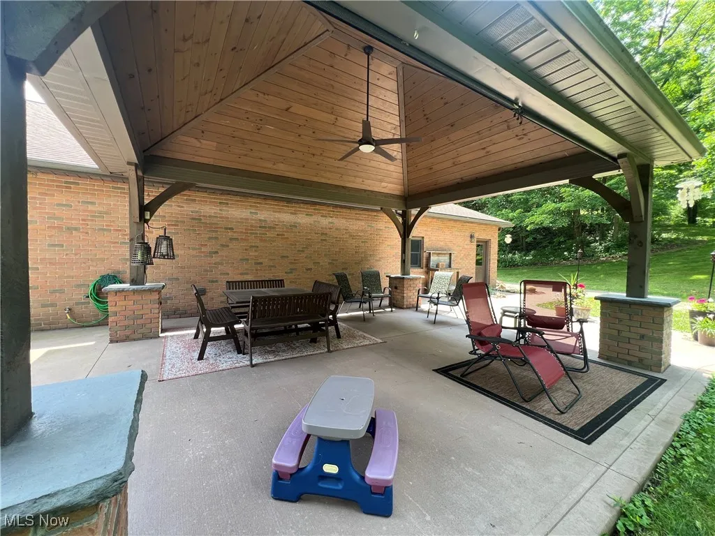 View of patio / terrace with ceiling fan, an outdoor hangout area, and a gazebo
