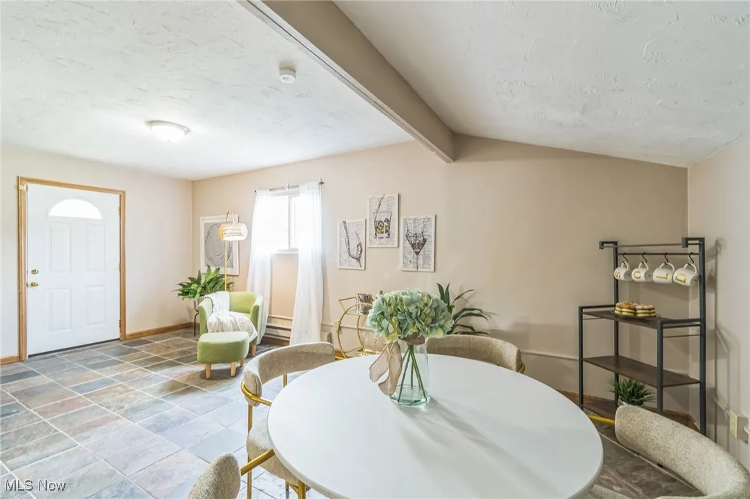 Dining room with a textured ceiling and stone finish flooring