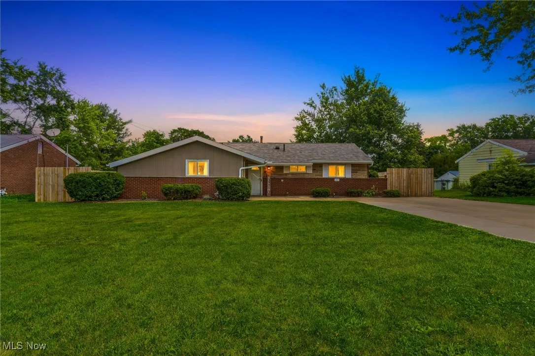 Ranch-style home featuring brick siding and concrete driveway