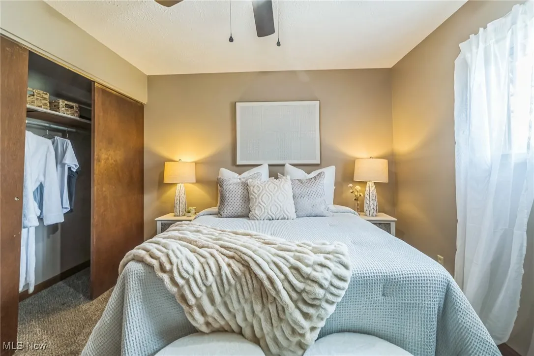 Bedroom featuring a closet, carpet, and ceiling fan