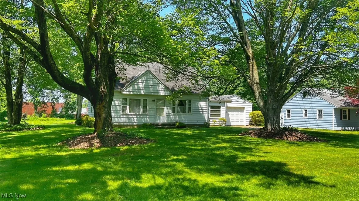 View of front of property with a garage and a front yard