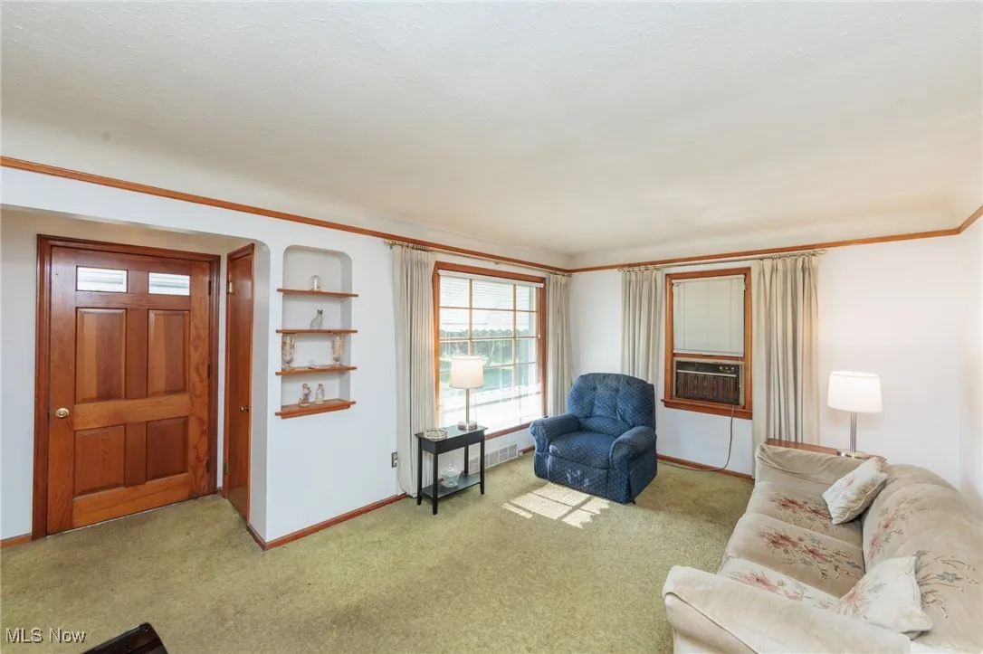 Living room featuring carpet and cooling unit
