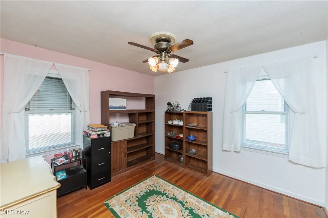 Office area featuring wood finished floors and a ceiling fan