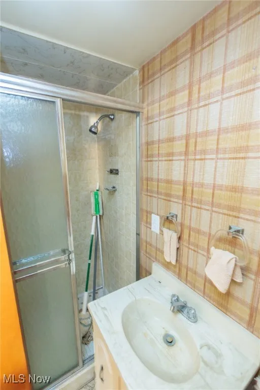 Bathroom featuring a stall shower and vanity