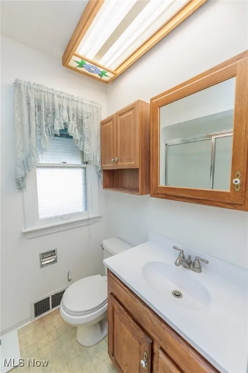 Full bathroom with vanity and an enclosed shower