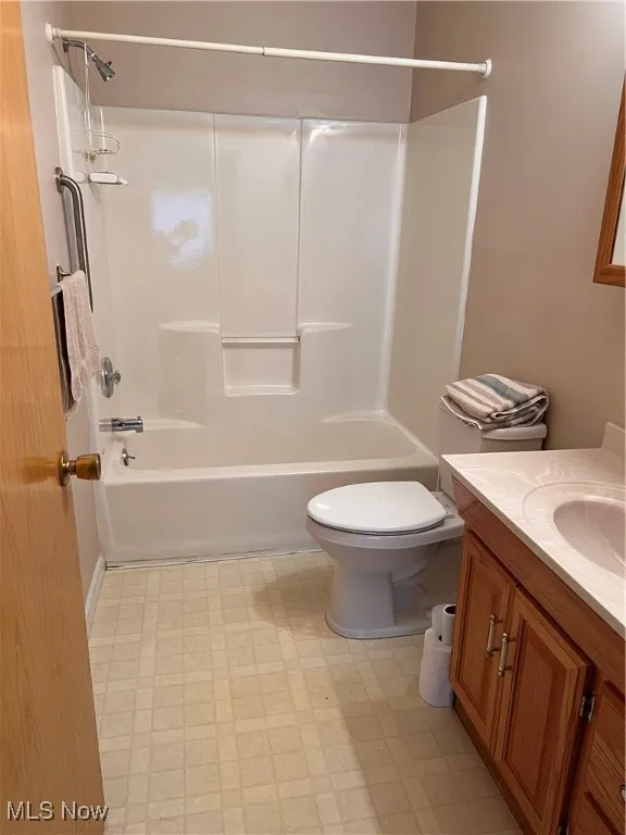 Full bath featuring vanity, tile patterned floors, and shower / washtub combination