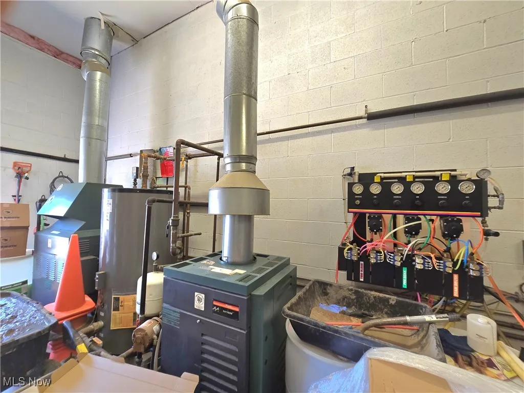 Utility room featuring gas water heater