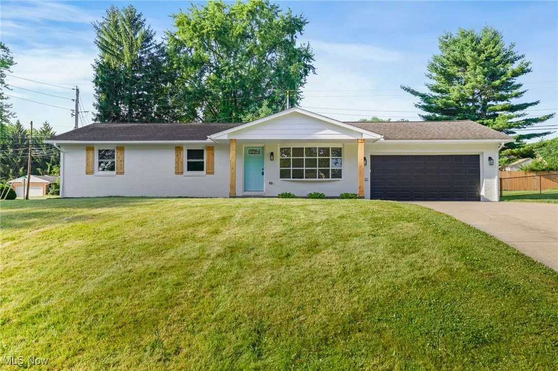 Single story home featuring an attached garage, concrete driveway, and stucco siding