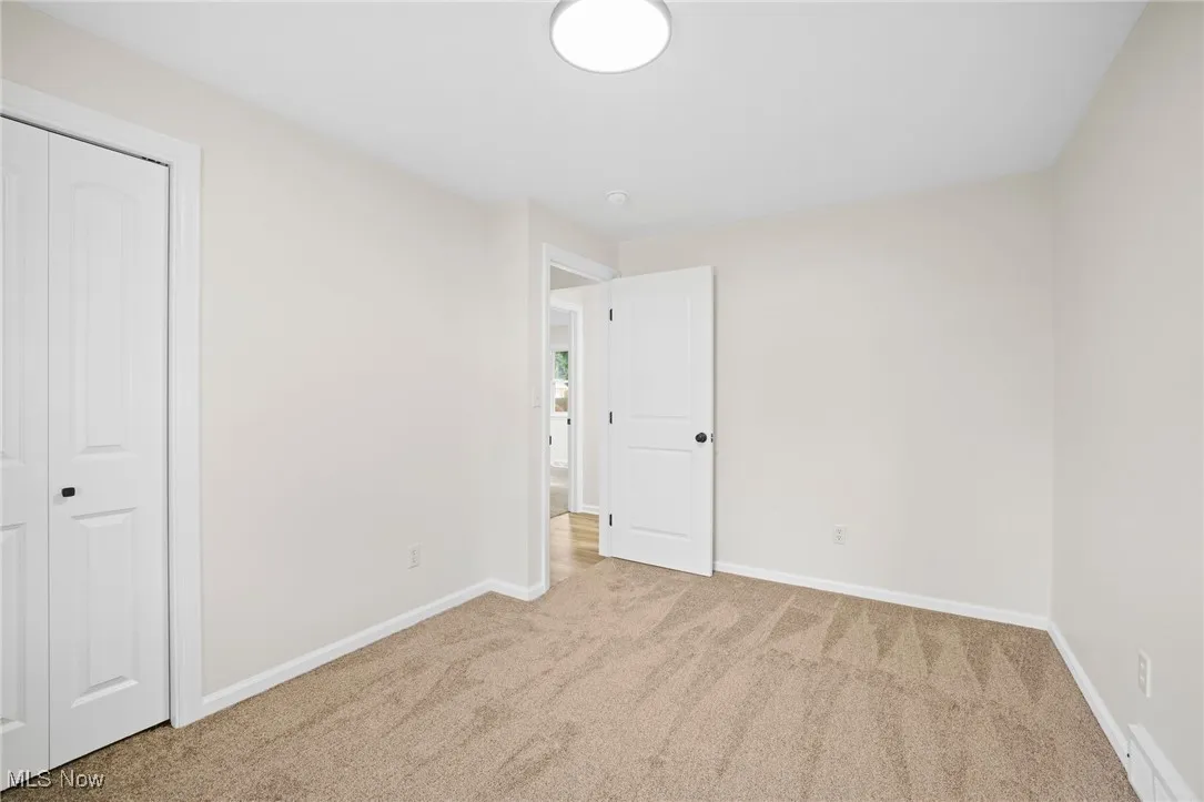 Unfurnished bedroom featuring carpet and a closet