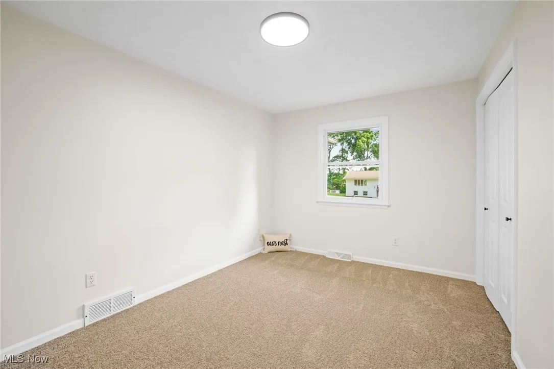 Unfurnished bedroom featuring carpet flooring and a closet