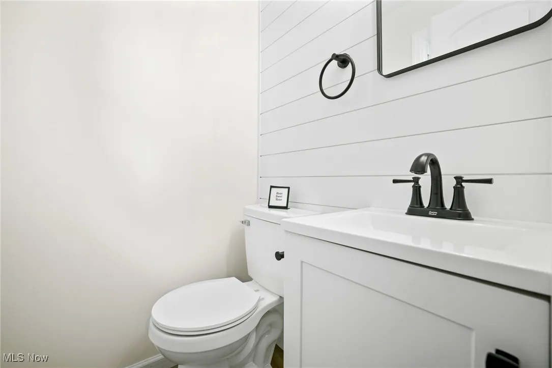 Half bath featuring toilet and vanity