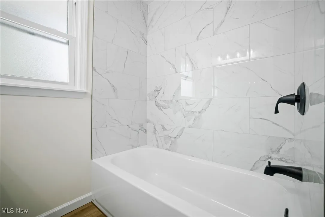 Full bathroom featuring baseboards