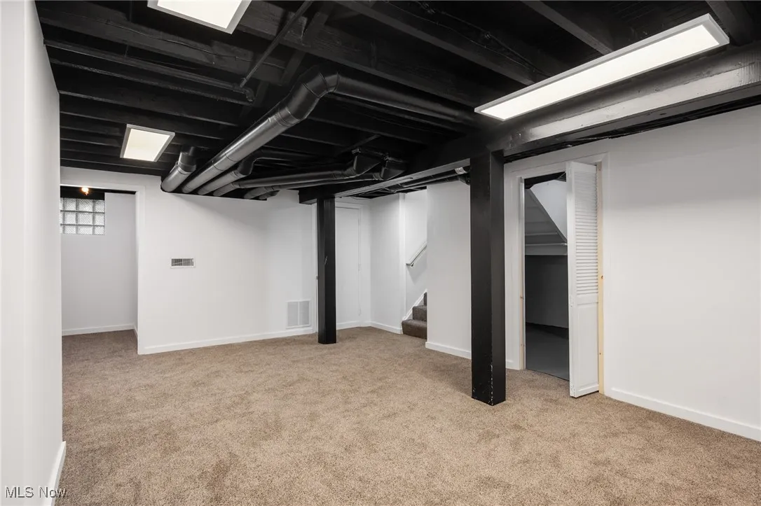 Basement featuring carpet floors and stairs