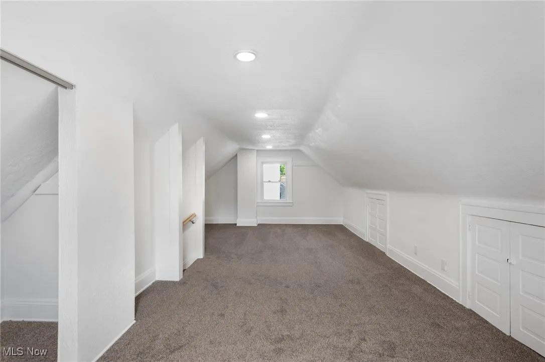Additional living space featuring carpet floors, lofted ceiling, and recessed lighting
