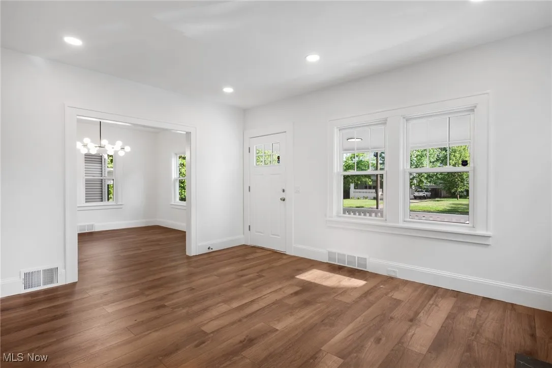 Entryway with a chandeliers and recessed lighting