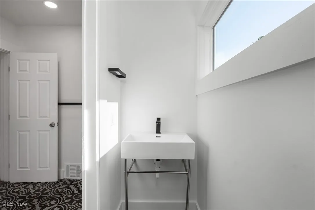 Bathroom with a sink and recessed lighting