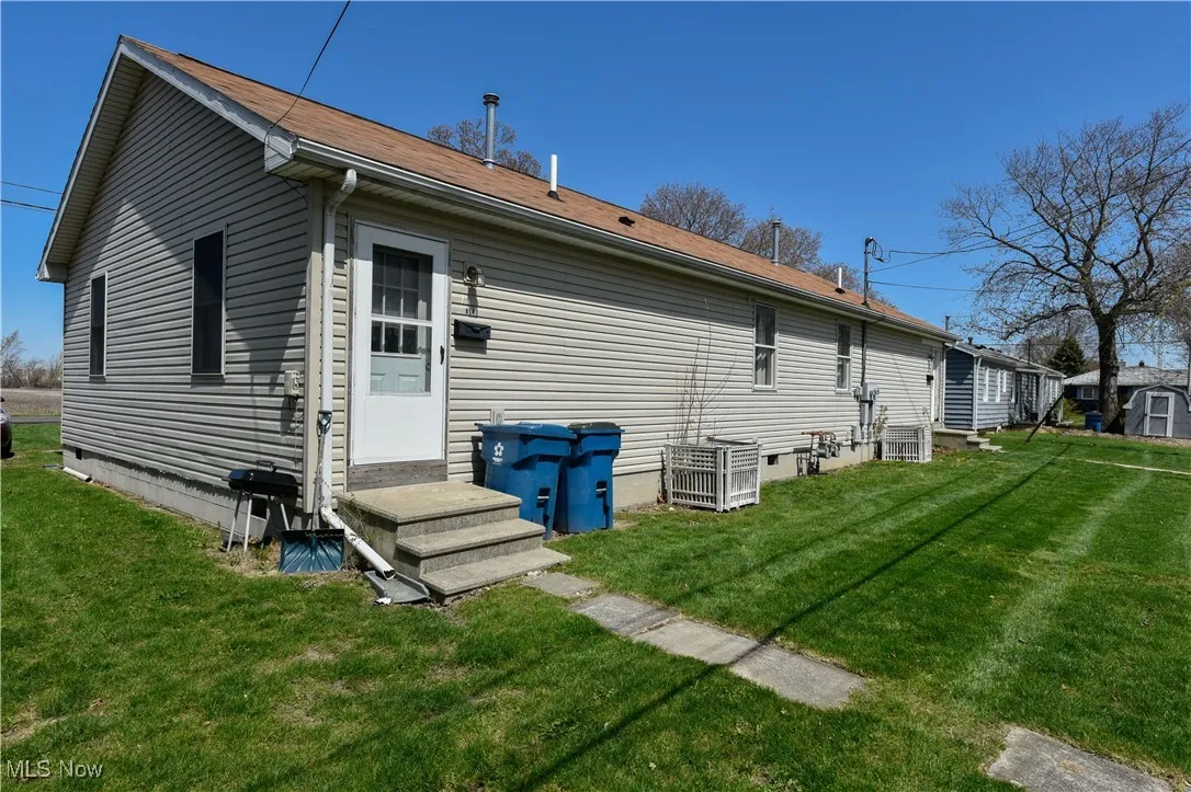 Back of house featuring a yard