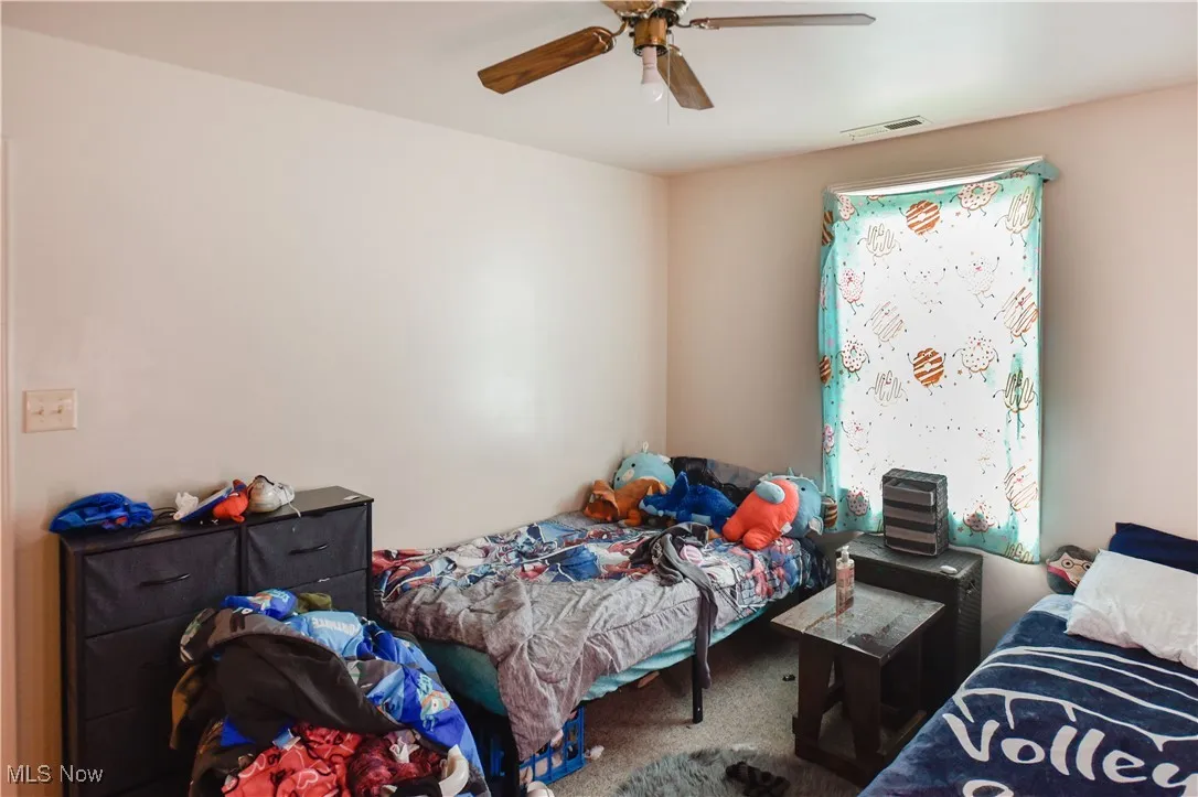 Bedroom with carpet floors and a ceiling fan