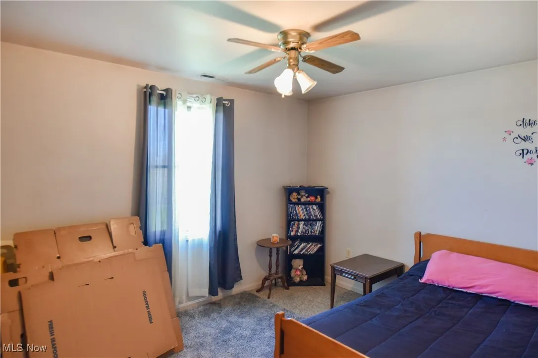 Bedroom with carpet flooring and ceiling fan