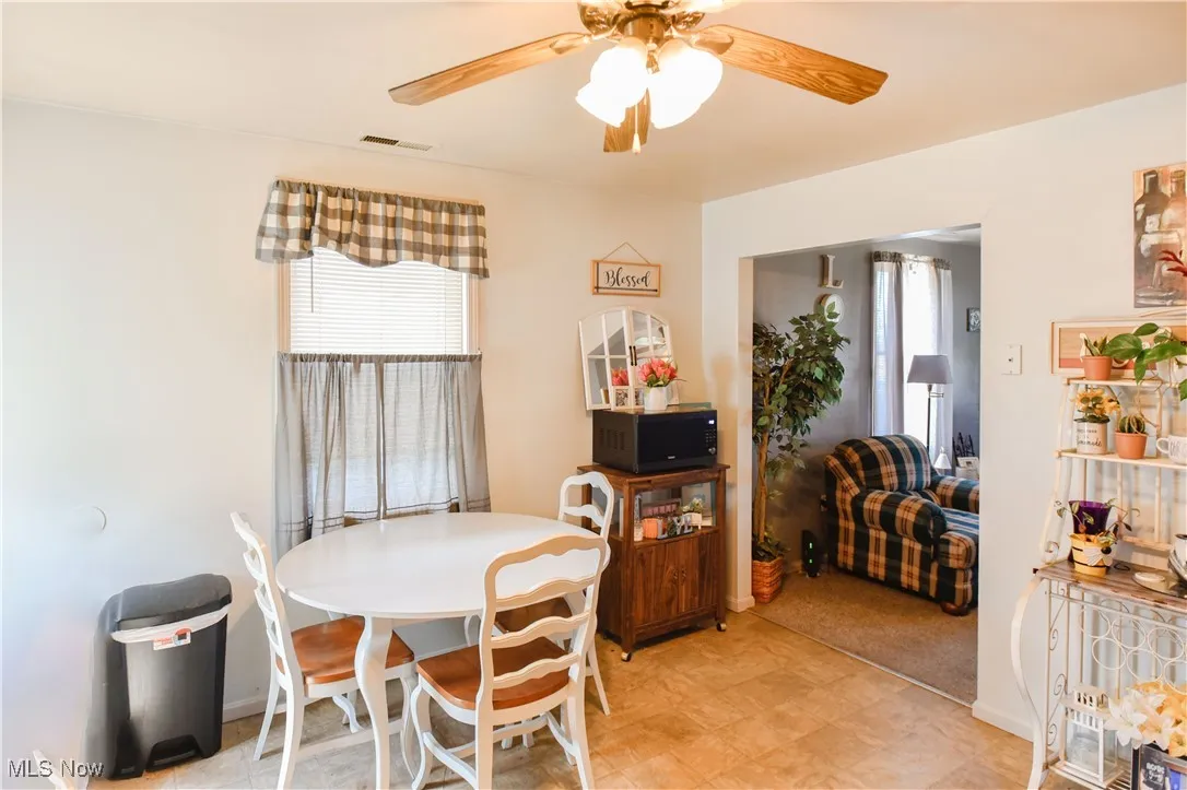 Dining room featuring plenty of natural light, ceiling fan, and light flooring