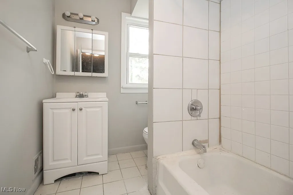 Full bathroom featuring vanity, tile patterned floors, and bathtub / shower combination