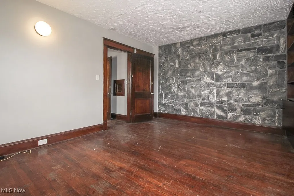 Spare room featuring hardwood / wood-style flooring and a textured ceiling
