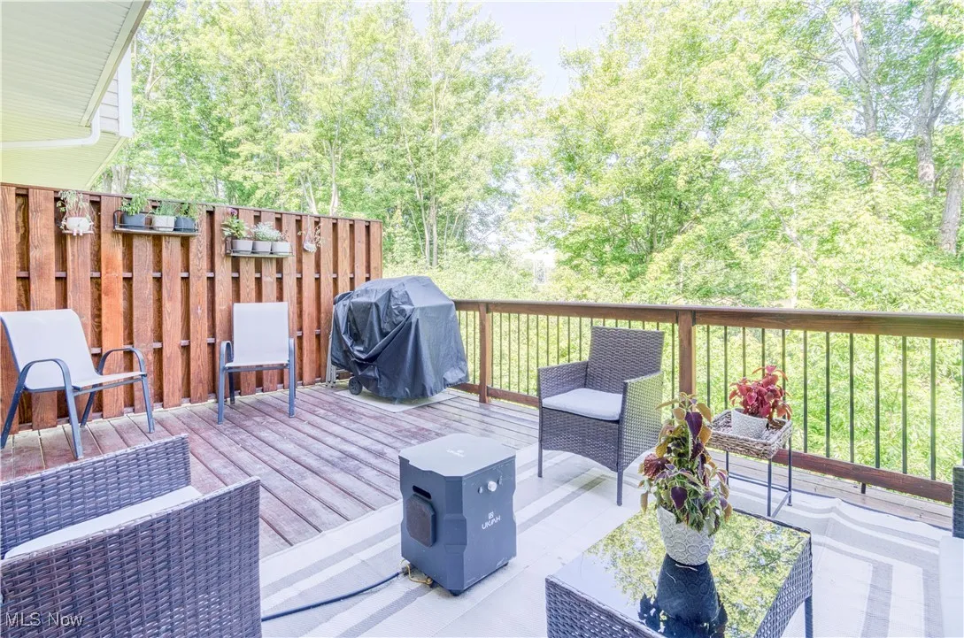 Wooden terrace featuring a grill