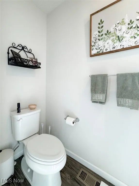 Bathroom featuring toilet and wood finished floors