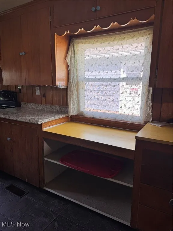 Kitchen with light countertops and range