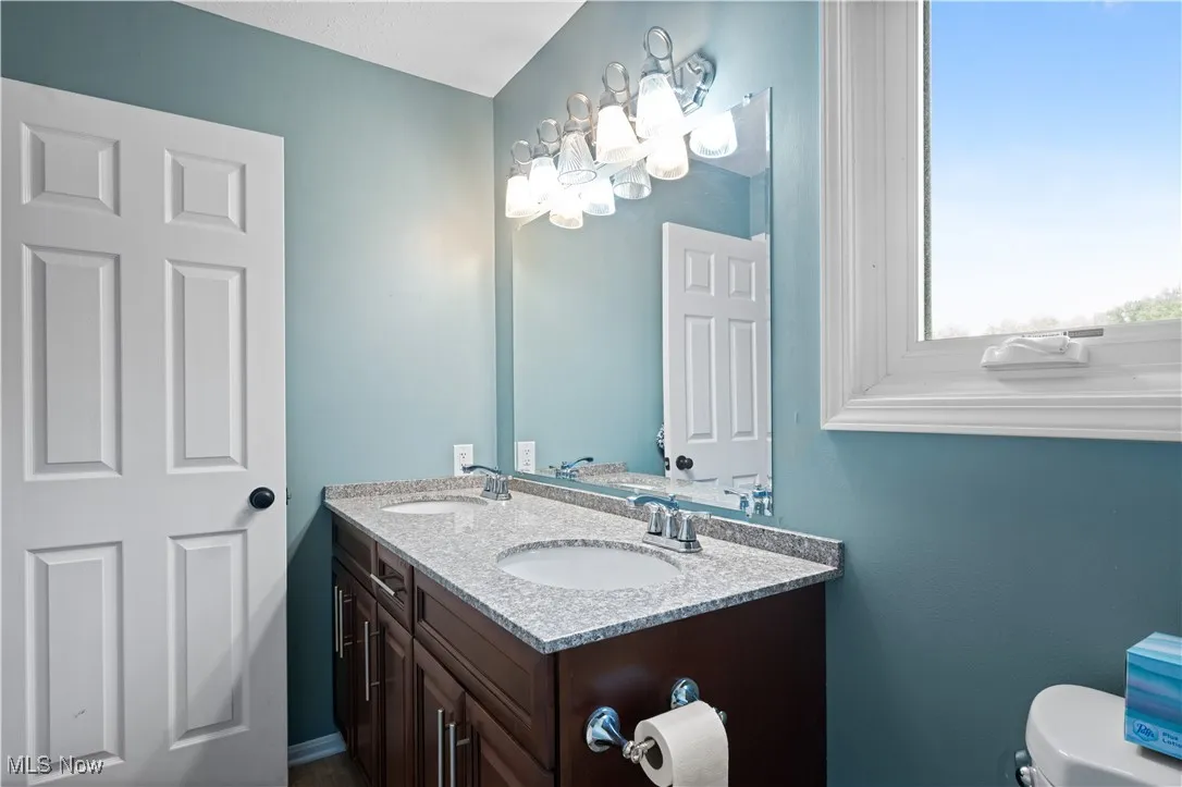 Bathroom with double vanity and a chandelier