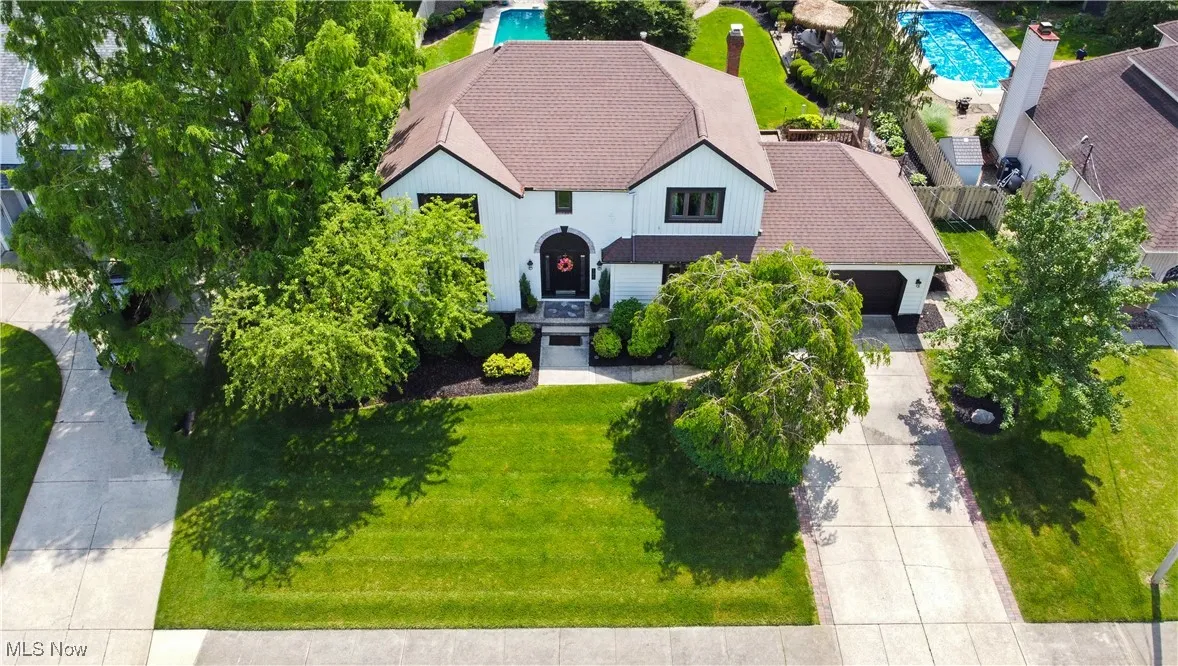 Aerial view of property and surrounding area with a pool
