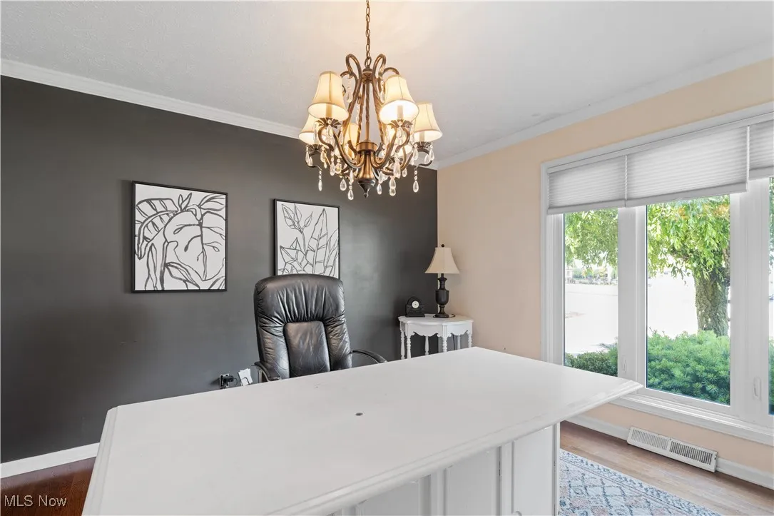 Office featuring crown molding, wood finished floors, and a chandelier