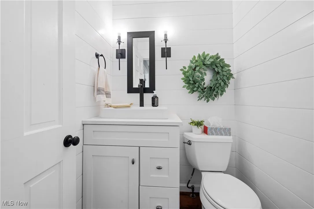 Half bath featuring toilet and vanity