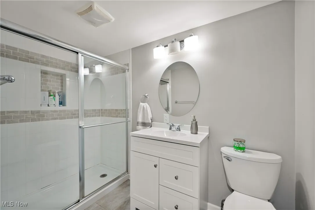 Full bathroom featuring a stall shower and vanity