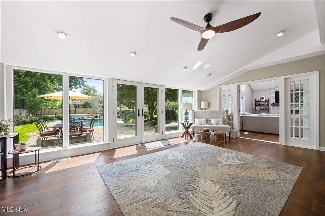 Bedroom with french doors, access to exterior, lofted ceiling, hardwood / wood-style floors, and recessed lighting