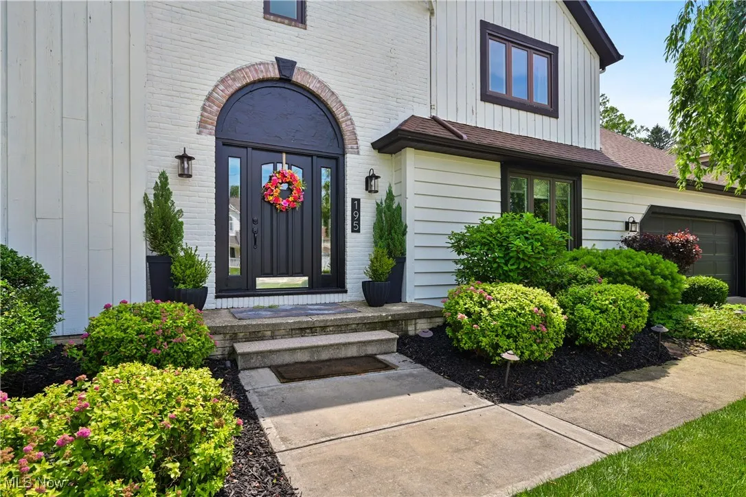 Doorway to property with brick siding and board and batten siding