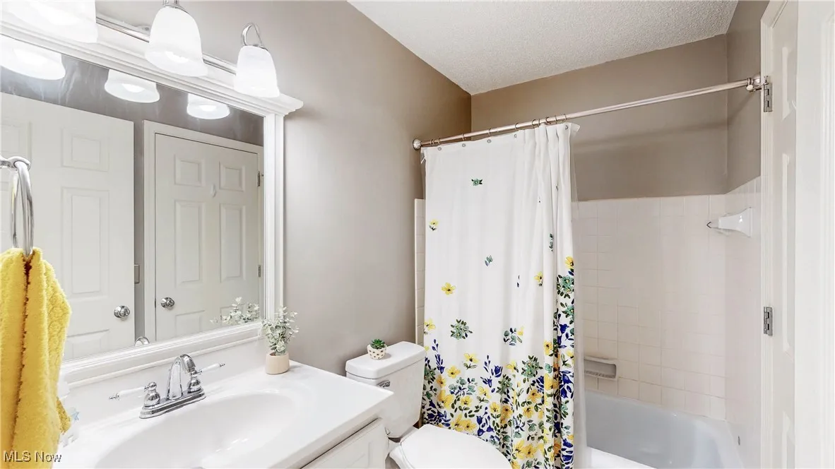 Bathroom with vanity and shower / bath combo