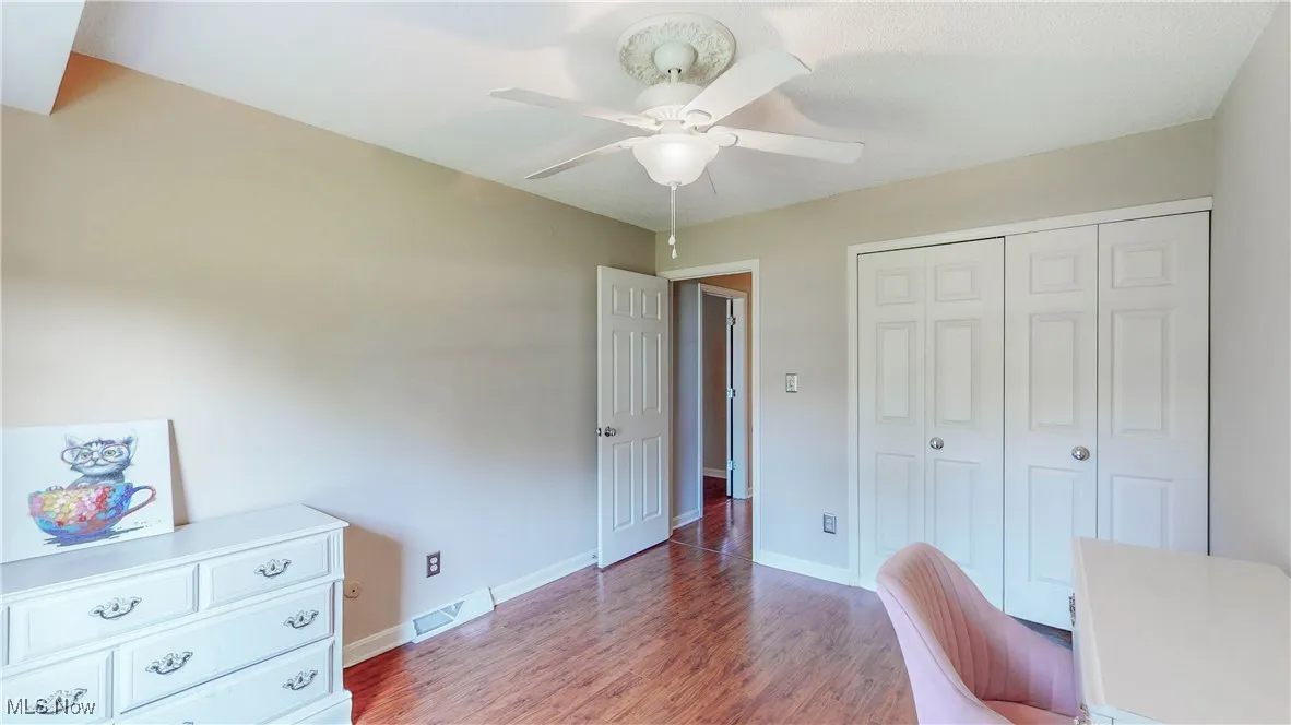 Office area with ceiling fan and wood finished floors