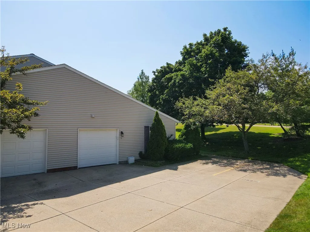 View of property exterior featuring a garage
