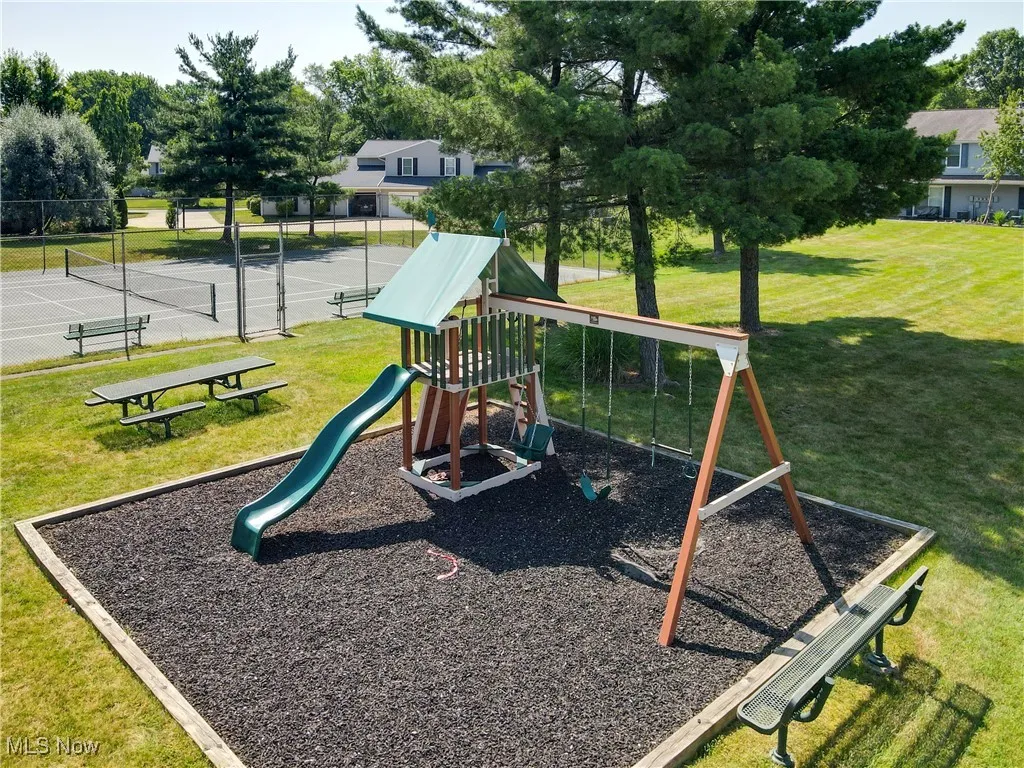 Community playground with a tennis court