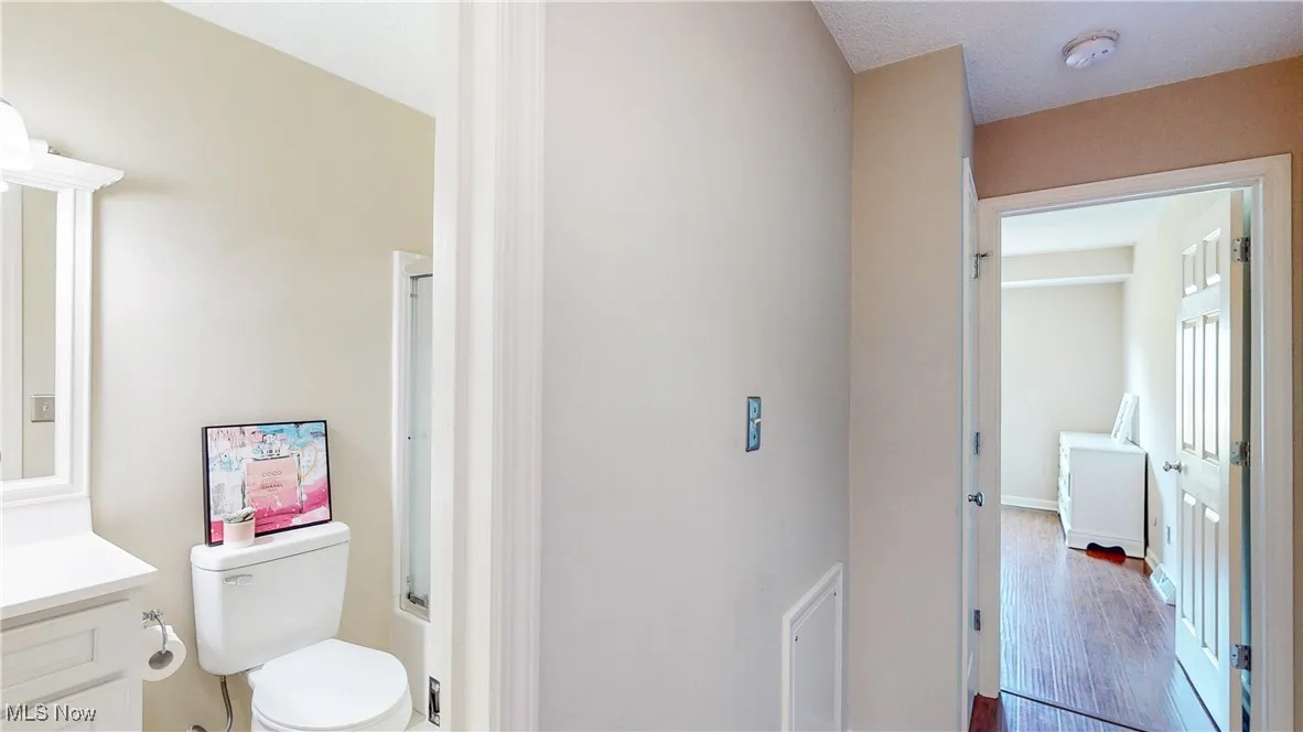 Full bath featuring vanity, wood finished floors, and a shower