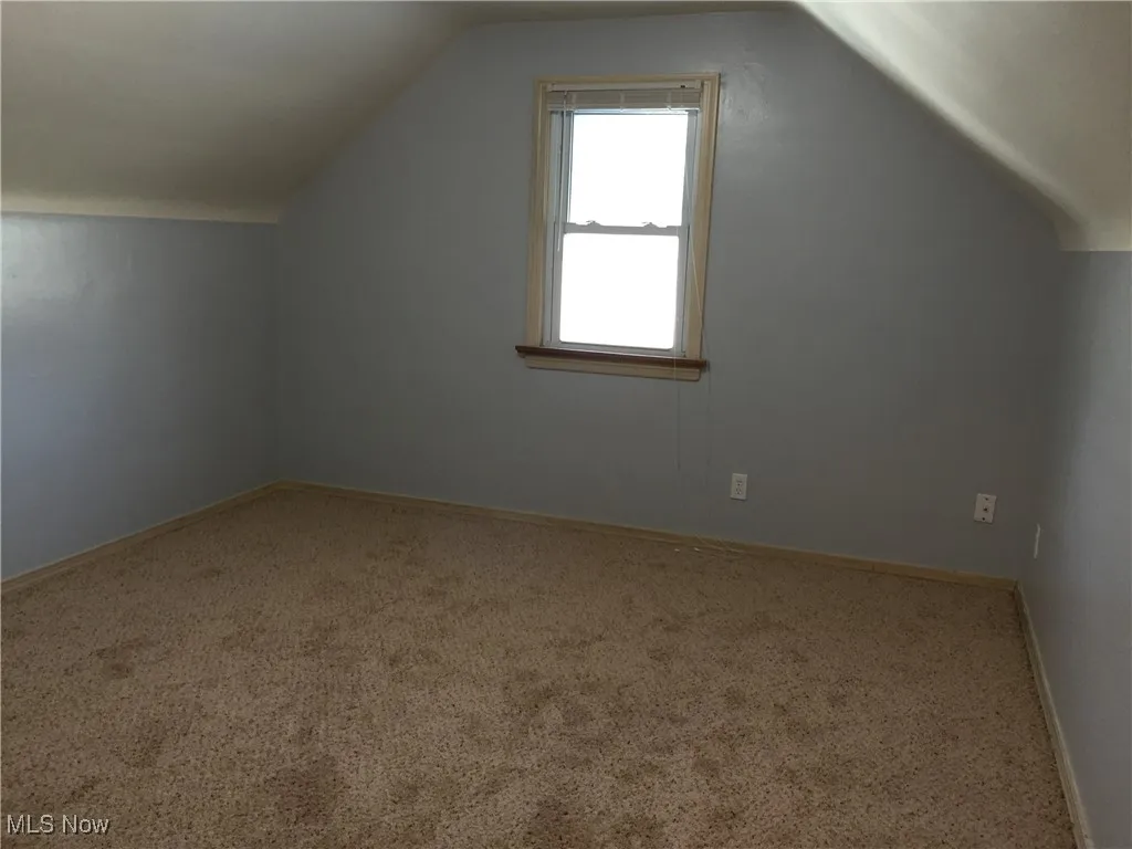 Bonus room featuring carpet floors and lofted ceiling