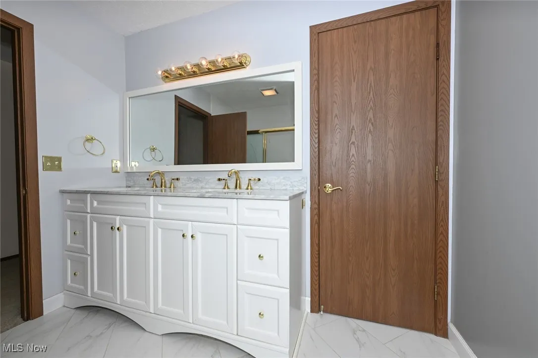 Bathroom with marble look tiles and double vanity