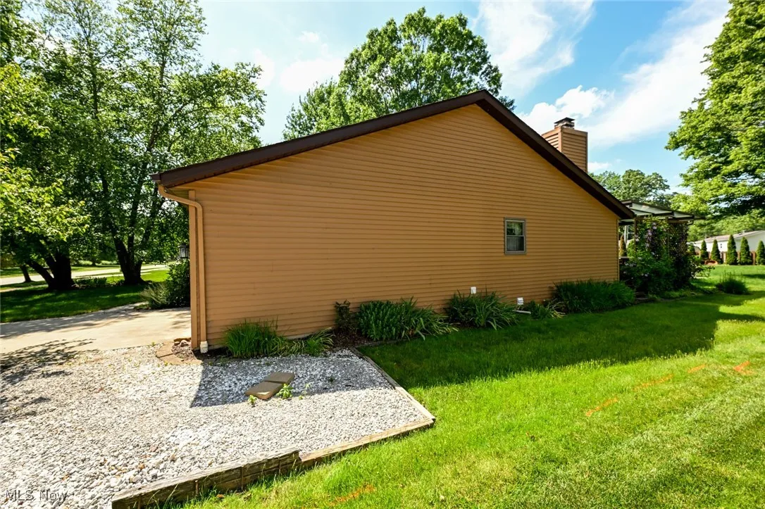 Side of home with additional parking area